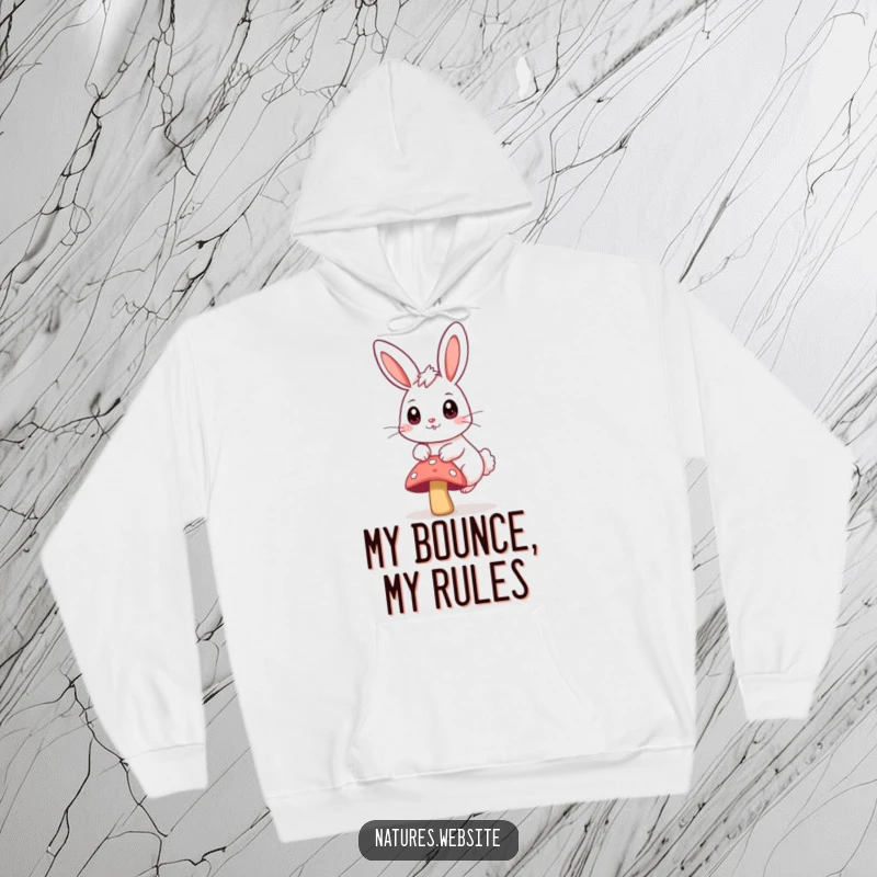 Funny hoodie showing a bouncing bunny with big curious eyes, happily hopping over a small mushroom.
